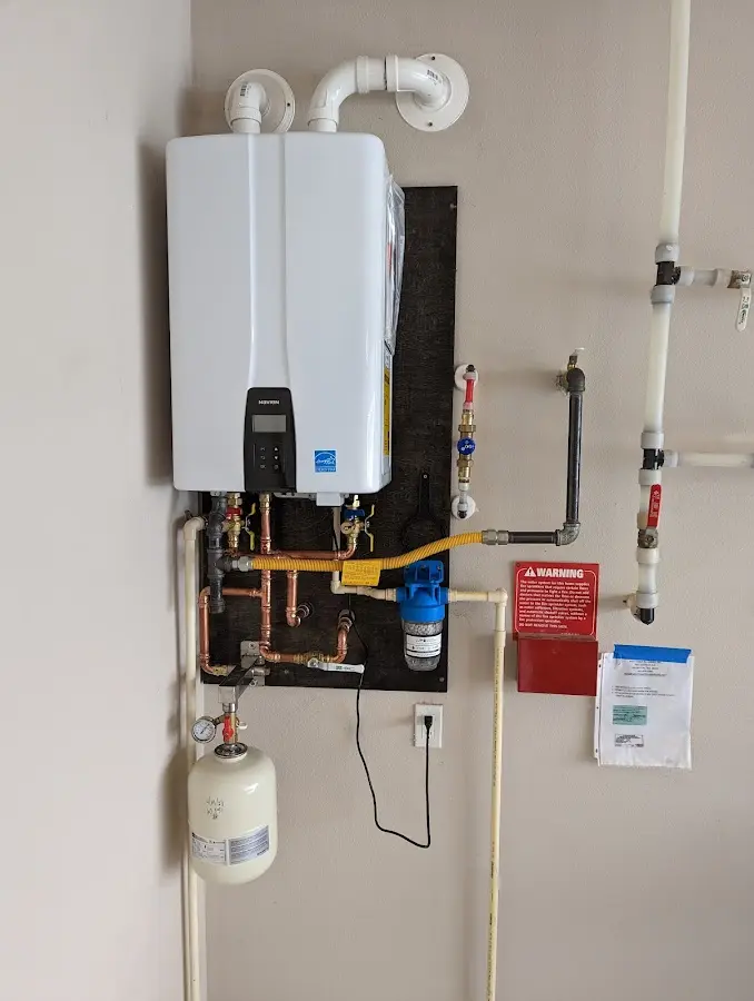 Professional plumber installing copper piping in a Ellington home